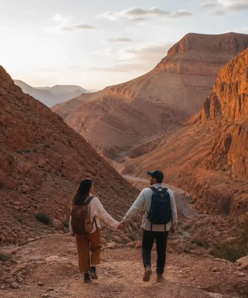 Couple walking at sunset in Serdrar Desert Morocco during a 3 day Dades Valley tour from Marrakech