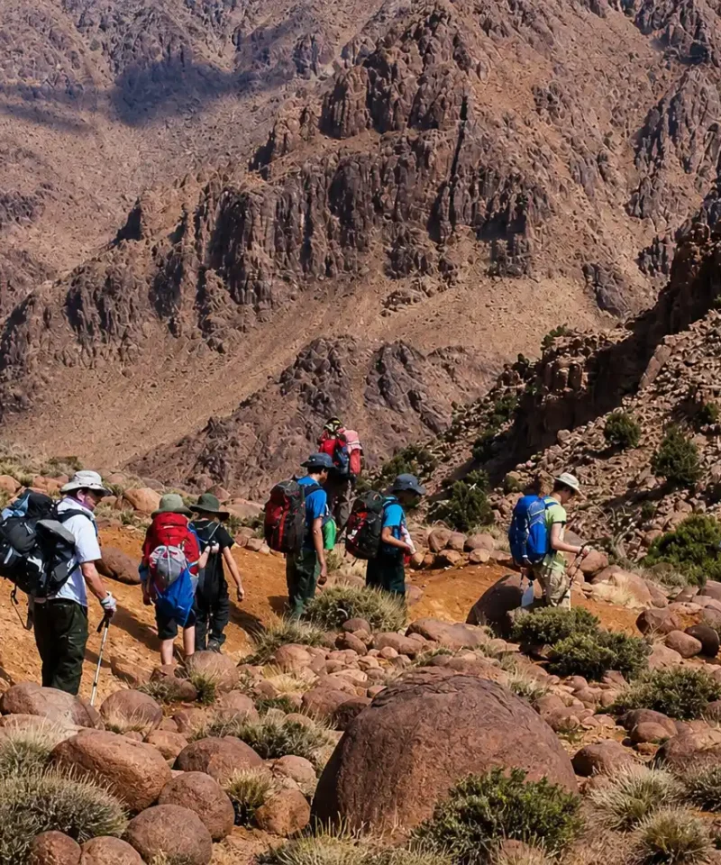 Group of hikers trekking in M Goun Valley near Ait Bouguemez in the High Atlas Mountains Morocco