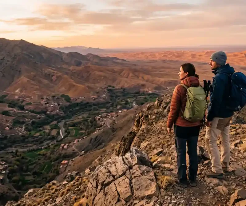 Couple overlooking the High Atlas Mountains and Sahara landscape during a multi day Morocco adventure tour